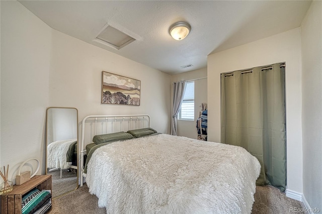 carpeted bedroom with a textured ceiling