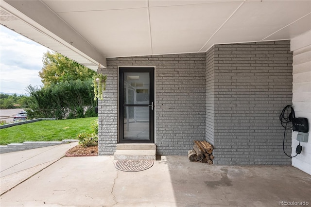 doorway to property with a yard