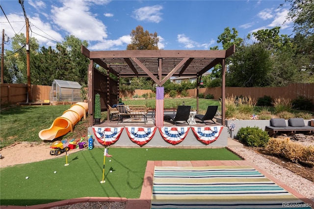 view of playground with a pergola, an outbuilding, and a patio