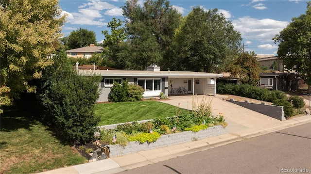 view of front facade with a front yard and a carport