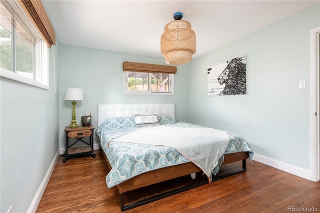 bedroom featuring multiple windows and hardwood / wood-style flooring