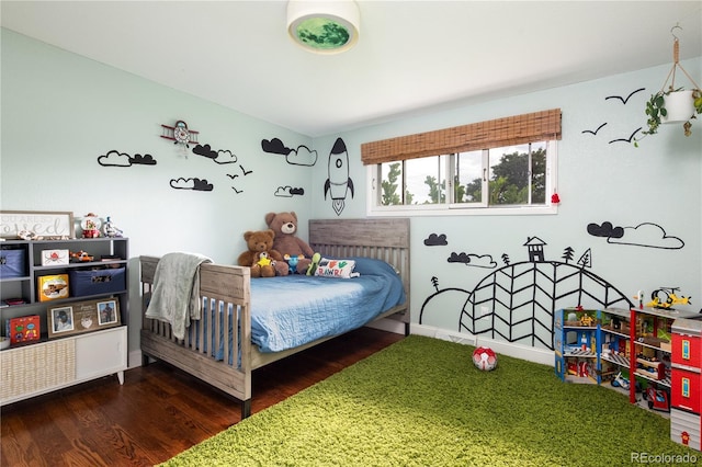 bedroom with dark wood-type flooring