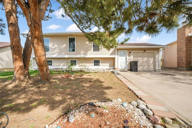 split level home featuring an attached garage and driveway
