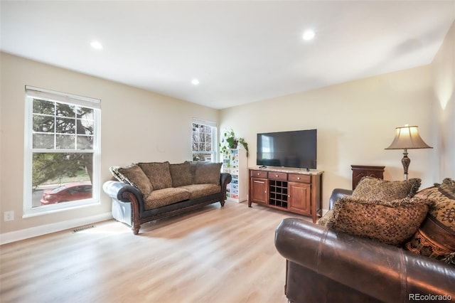 living area with light wood finished floors, recessed lighting, and baseboards