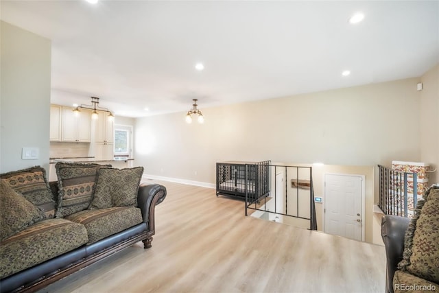 living area with light wood-style flooring, recessed lighting, and baseboards