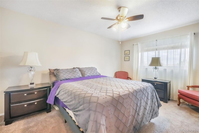 bedroom with light colored carpet and a ceiling fan