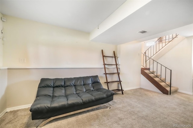 carpeted living area featuring baseboards and stairway