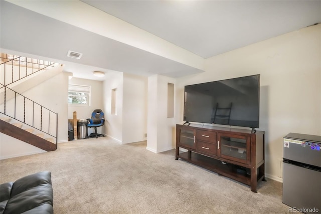 carpeted living room featuring stairway and baseboards