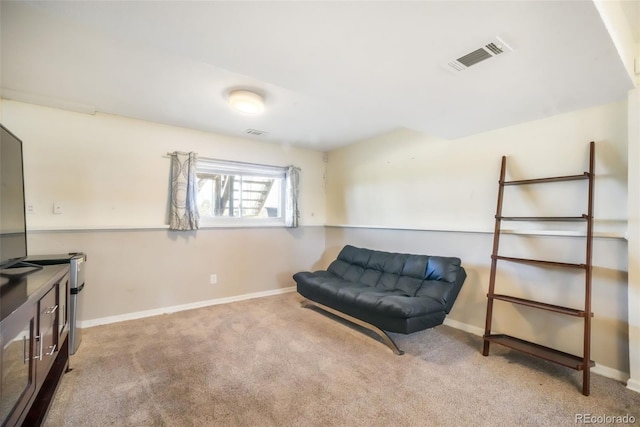 living area featuring carpet and baseboards