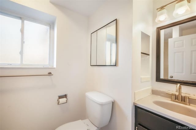 half bathroom with toilet and vanity