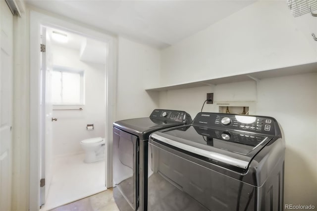 washroom featuring washer and clothes dryer