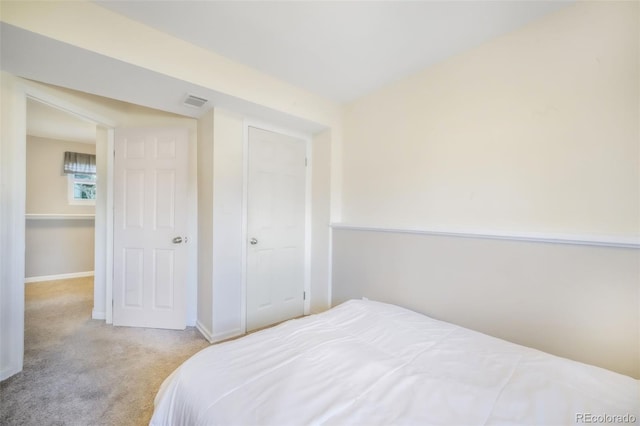 bedroom with carpet floors and baseboards