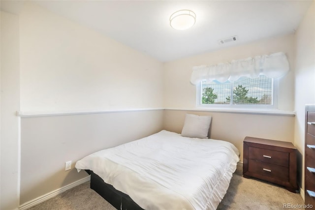 carpeted bedroom with baseboards