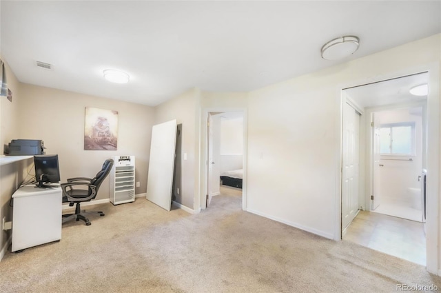 carpeted home office with baseboards