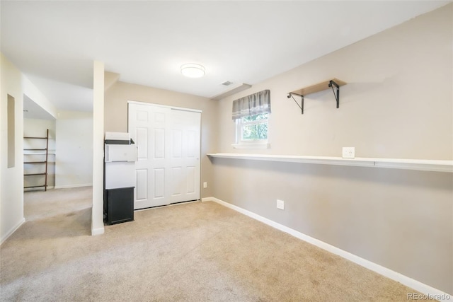 unfurnished bedroom featuring baseboards, carpet floors, and a closet