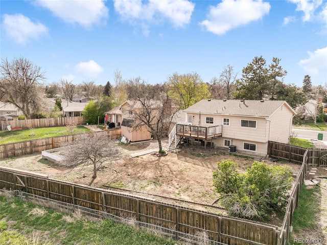 back of house featuring a deck, stairs, a fenced backyard, and a residential view