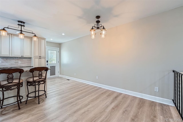 15691 E Atlantic Cir, Aurora, CO 80013 - dining area featuring light wood-style floors, baseboards, recessed lighting, and a chandelier