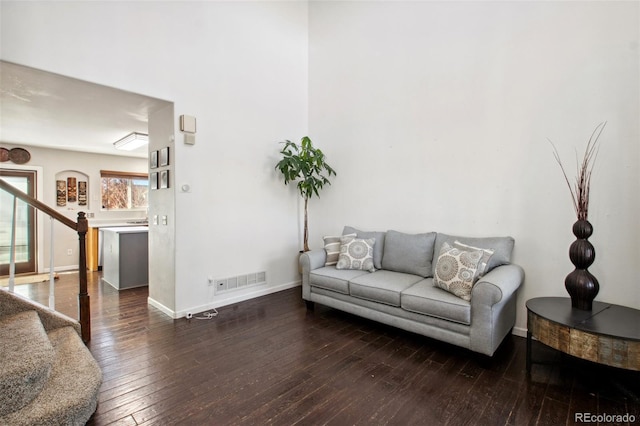 living room featuring dark wood-type flooring