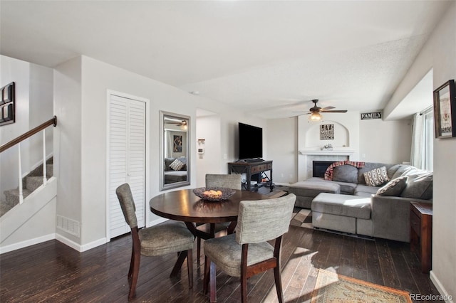 dining space featuring ceiling fan and dark hardwood / wood-style flooring