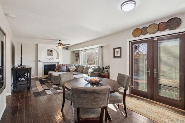 dining room featuring plenty of natural light, ceiling fan, dark wood-type flooring, and french doors