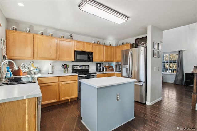 kitchen with sink, dark hardwood / wood-style floors, light brown cabinetry, a kitchen island, and appliances with stainless steel finishes