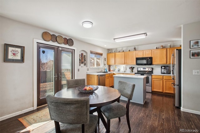 kitchen with sink, dark wood-type flooring, french doors, and appliances with stainless steel finishes