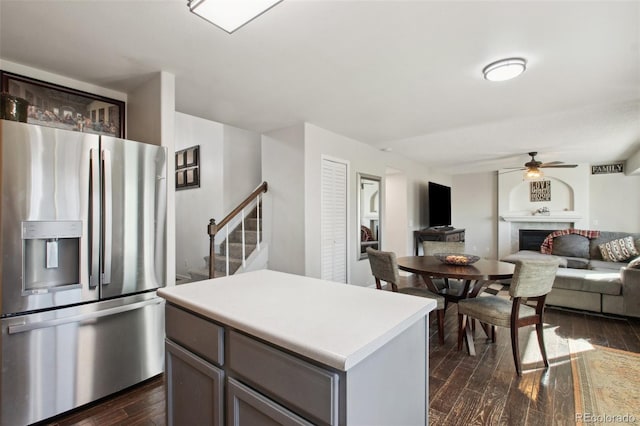 kitchen featuring a center island, stainless steel refrigerator with ice dispenser, and dark wood-type flooring