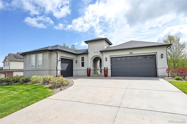 view of front of house with a front yard and a garage