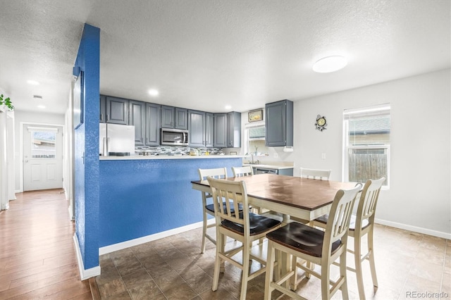 dining area with a textured ceiling and sink