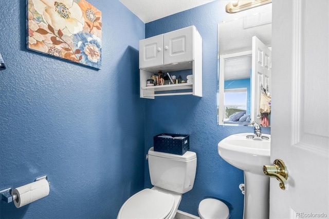 bathroom with toilet and sink