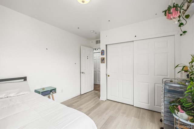 bedroom featuring light hardwood / wood-style flooring and a closet