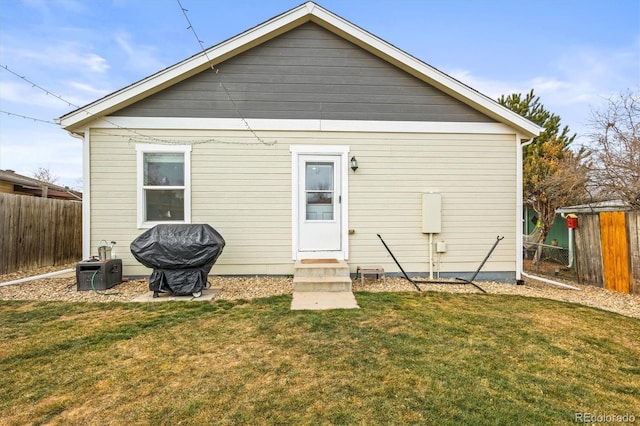 rear view of property with a yard