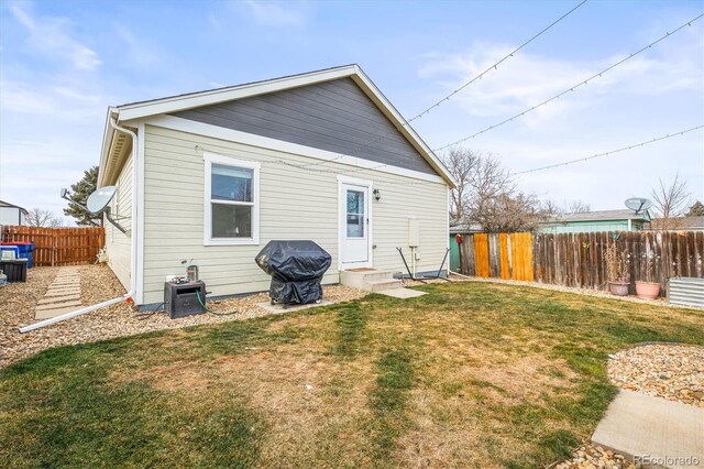 back of house with a lawn