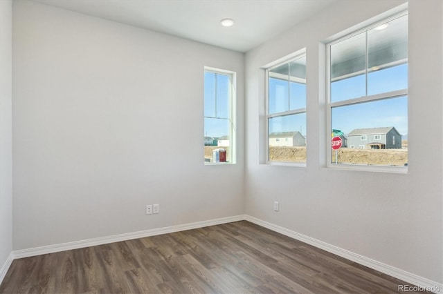 spare room with dark hardwood / wood-style flooring