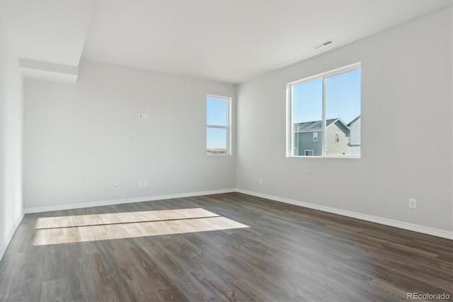 spare room with dark wood-type flooring