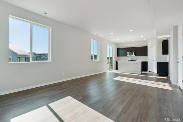 unfurnished living room with dark wood-type flooring