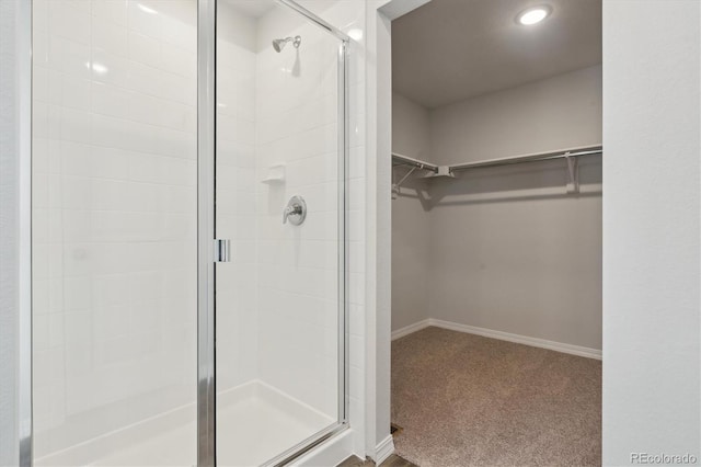 bathroom with a shower with door