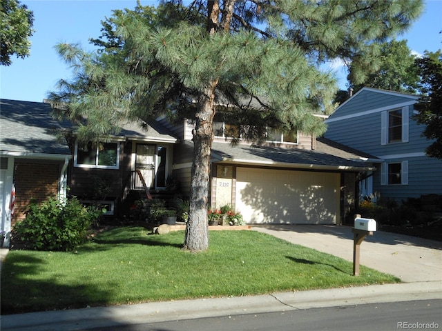 view of front of home featuring concrete driveway, a front lawn, and a shingled roof