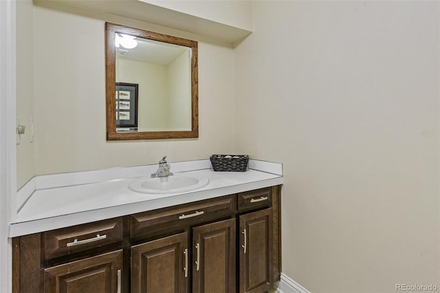 bathroom featuring baseboards and vanity