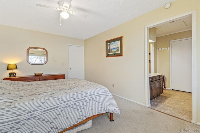 bedroom with a ceiling fan, light carpet, a textured ceiling, and baseboards