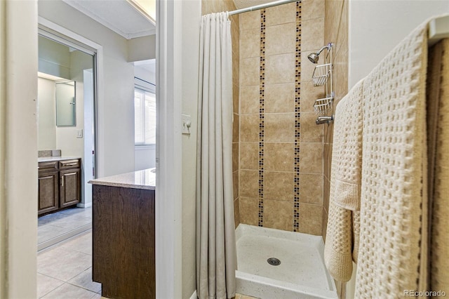 full bath with ornamental molding, a stall shower, tile patterned flooring, and vanity