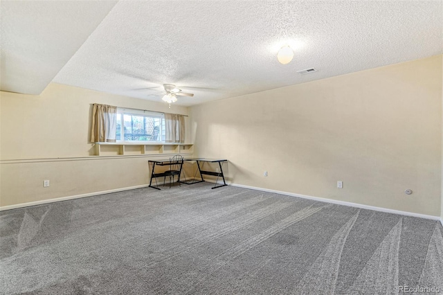 unfurnished room featuring carpet floors, baseboards, visible vents, and a textured ceiling