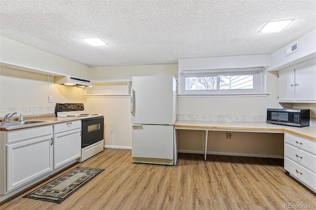 kitchen featuring white appliances, light wood-style flooring, range hood, built in desk, and a sink