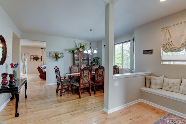 1995 E 166th Ave, Thornton, CO 80602 - dining space with wood finished floors, a chandelier, and baseboards