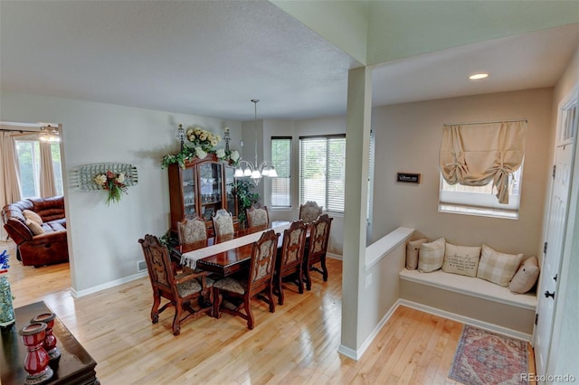 1995 E 166th Ave, Thornton, CO 80602 - dining space with wood-type flooring, a chandelier, and baseboards