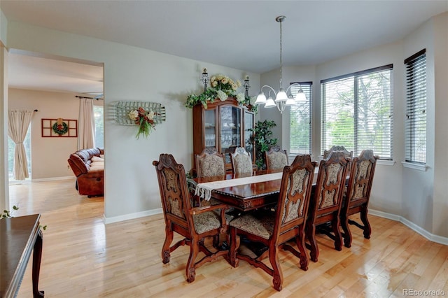 1995 E 166th Ave, Thornton, CO 80602 - dining space with light wood-type flooring, a chandelier, and baseboards