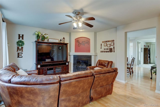 1995 E 166th Ave, Thornton, CO 80602 - living room featuring a fireplace, ceiling fan, light wood finished floors, and baseboards