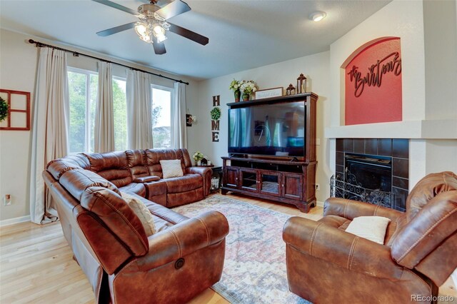 1995 E 166th Ave, Thornton, CO 80602 - living room with wood finished floors, ceiling fan, a fireplace, and baseboards