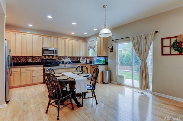 1995 E 166th Ave, Thornton, CO 80602 - kitchen featuring appliances with stainless steel finishes, backsplash, light brown cabinetry, dark countertops, and recessed lighting