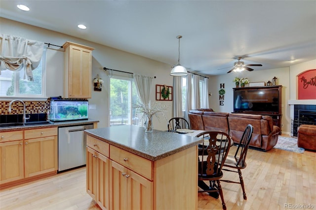 1995 E 166th Ave, Thornton, CO 80602 - kitchen with stainless steel dishwasher, light brown cabinets, a sink, dark countertops, and recessed lighting